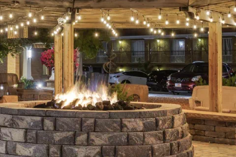 Outdoor fire pit and patio area at night