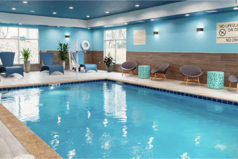 Modern indoor swimming pool with lounge seating